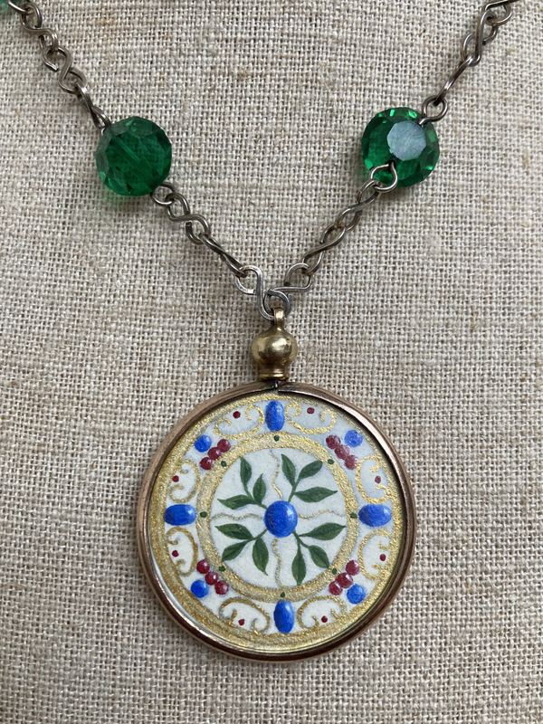 Art Deco round pendant. On a green crystal chain