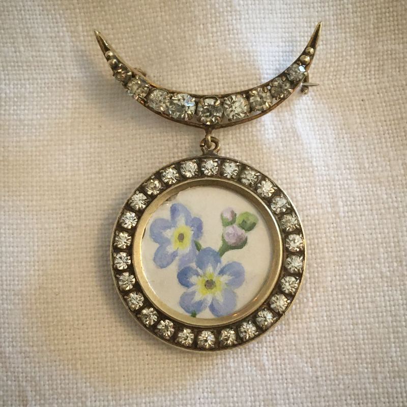 Forget-me-not. Hung from an antique paste crescent brooch