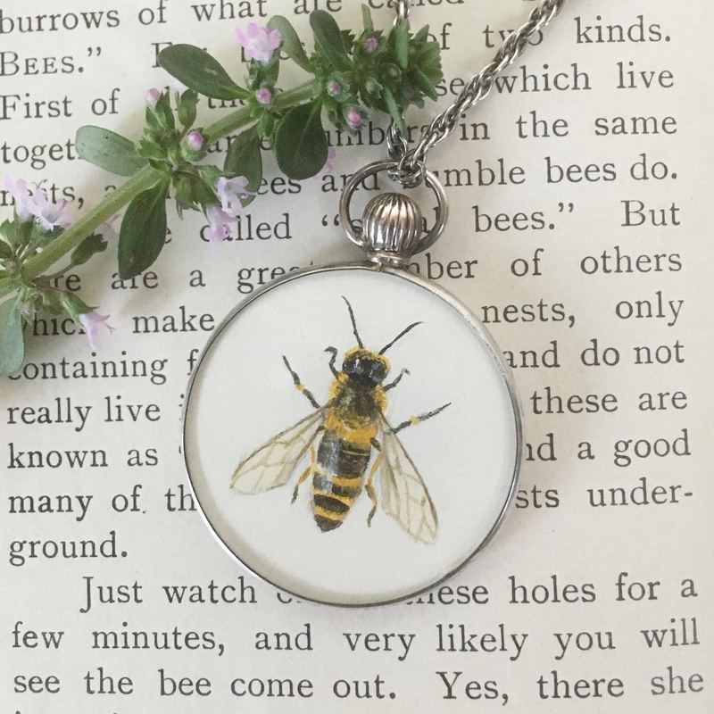Honey bee. In a round glass locket