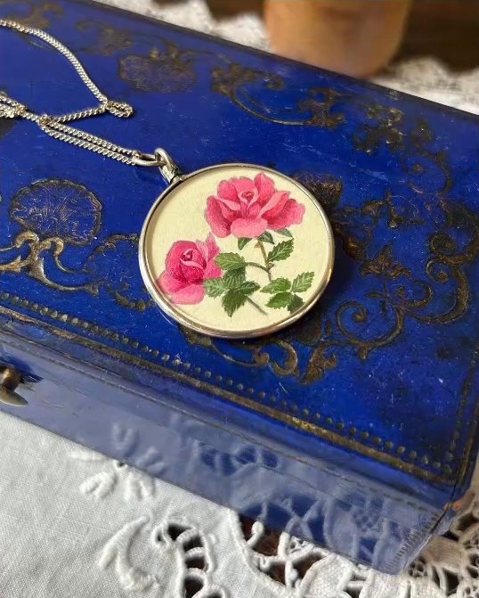 Pink roses. In a vintage silver locket pendant